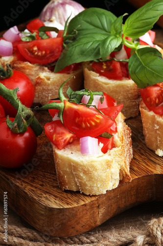 Bruschetta with tomatoes  herbs and oil on toasted garlic cheese bread toasted with chopped tomatoe