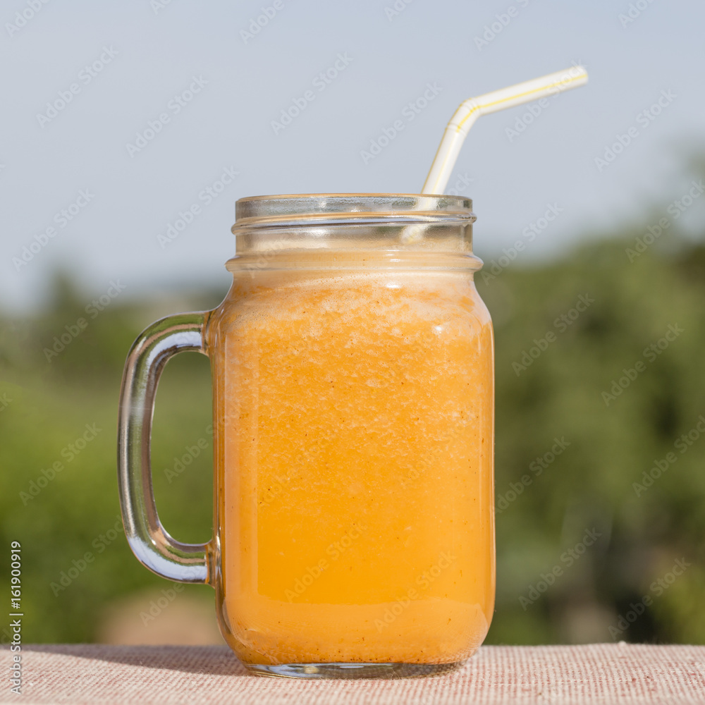 Smoothies from carrot, lemon, honey and banana in glass Smoothies from carrot, lemon, honey and banana in glass