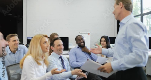 Group of Business People Discussing Documents With Businessman Leading Presentation At Seminar Training Meeting Slow Motion 60