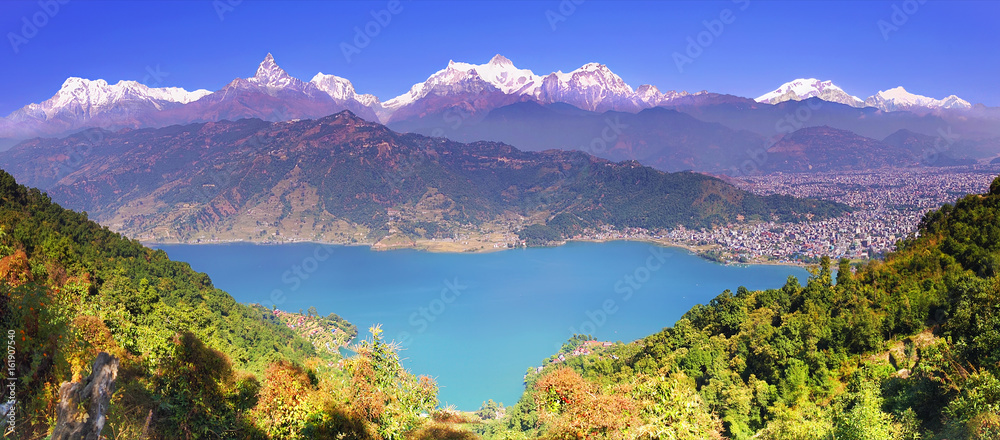Himalayas. Horizontal panoramic view to Pokhara valley,  Phewa lake and the magnificent Annapurna mountain range from hillside.