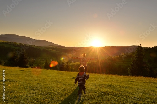 Kid running at sunset in the mountains