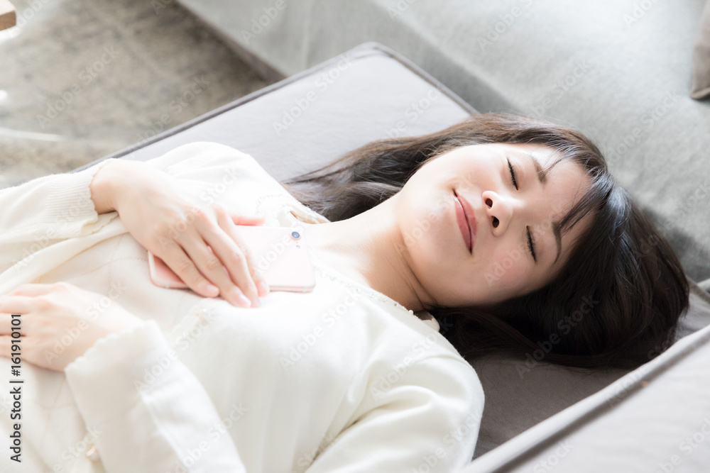 attractive asian woman relaxing on sofa attractive asian woman relaxing on sofa