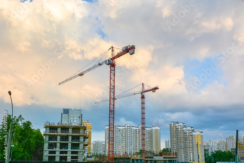 Cranes are on the construction site of residential buildings