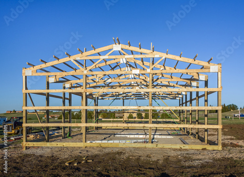 Garage construction in suburbia, USA. Wood, wooden roof truss system. Suburban building.