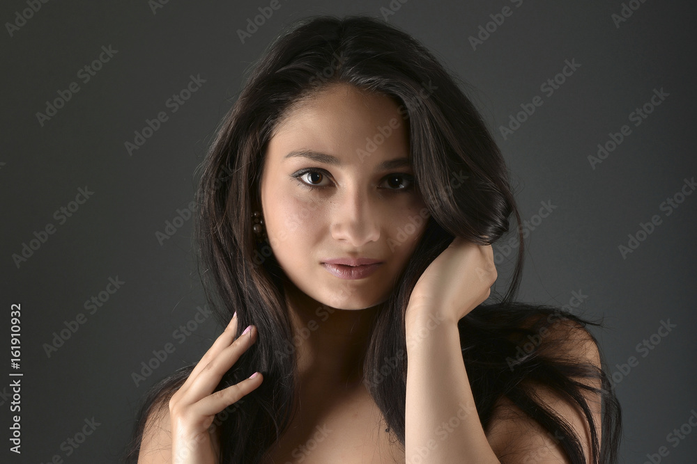 Beautiful woman posing in studio on dark background