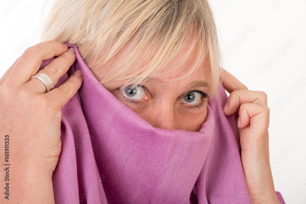 beautiful european mid aged woman hiding her face behind a shawl - studio shot on white background beautiful european mid aged woman hiding her face behind a shawl - studio shot on white background