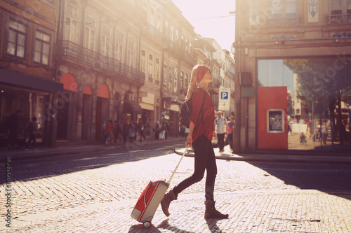 Canvas Print Woman tourist walking with suitcase on  European city street, tourism in Europe,