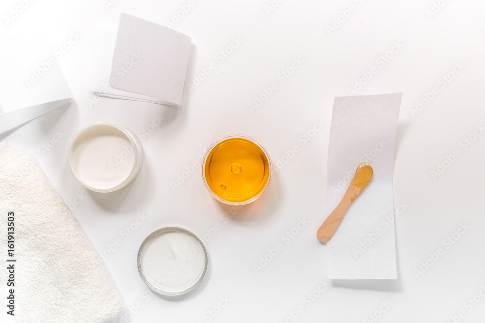 Set for depilation with wax on white background top view Set for depilation with wax on white background top view
