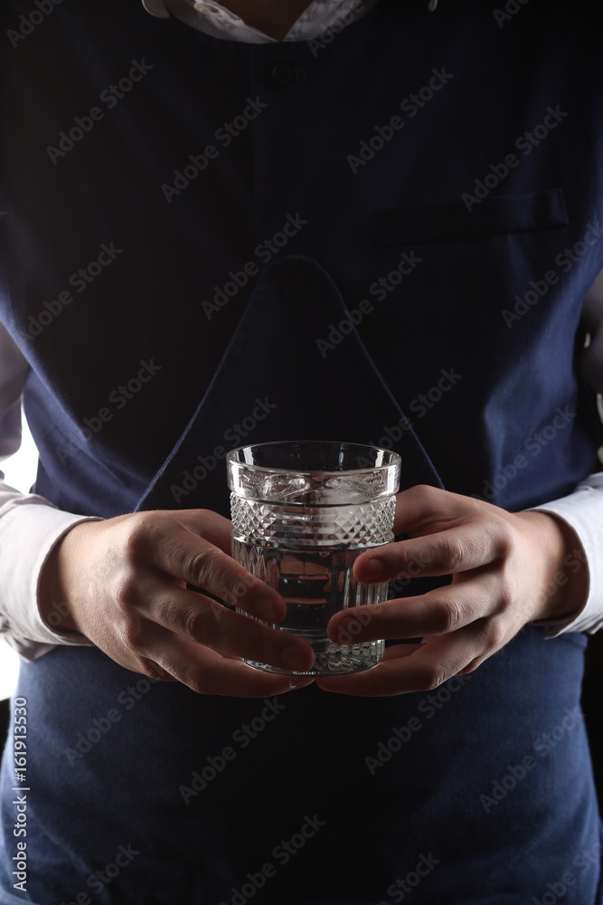 Glass of water in mans hands