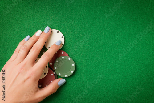 Woman hand holding poker ch...