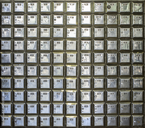 Wall full of rows of metal post office boxes