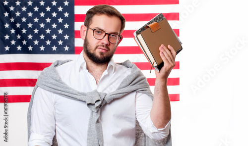 Smiling young man on United States flag background. photo