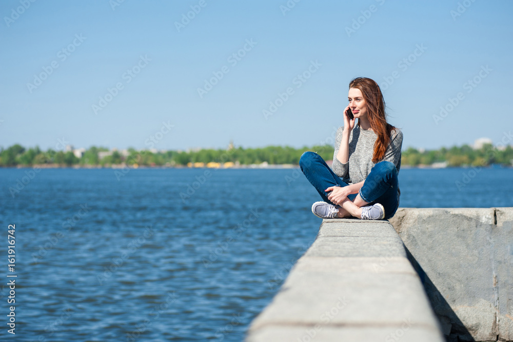 girl is sitting on a parapet 01