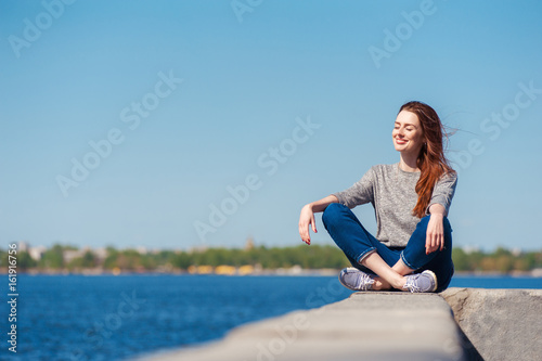 girl is sitting on a parapet 04