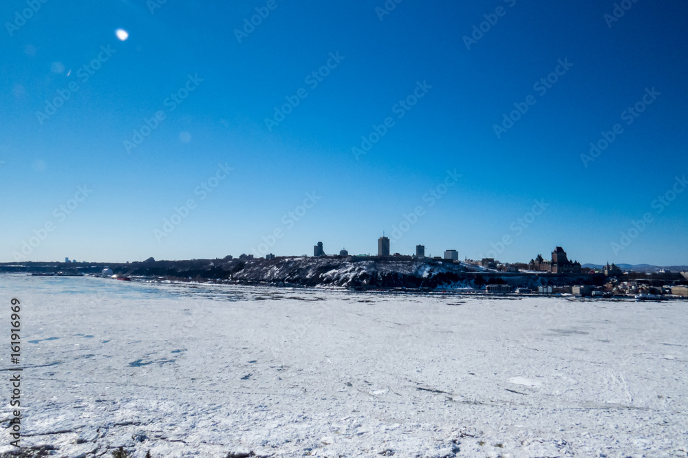 Distant Quebec City with A frozen part of the Sant-Lawrence River, Canada.