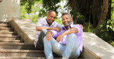 Portrait Of Two Gay Men Smiling At Camera In Park