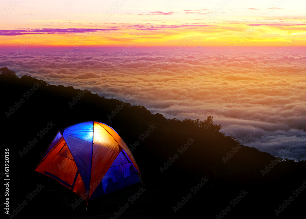 Camping with tent under beautiful landscape in sunrise with foggy on forest at north of Thailand 