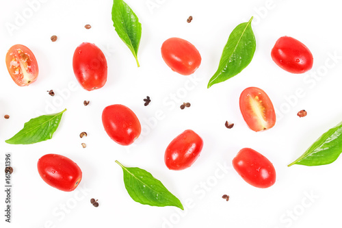 Cherry tomatoes with basil leaf on a white background