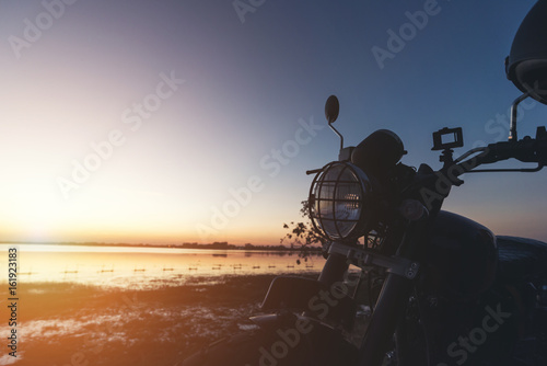 Silhouette of motorcycle with sunset background