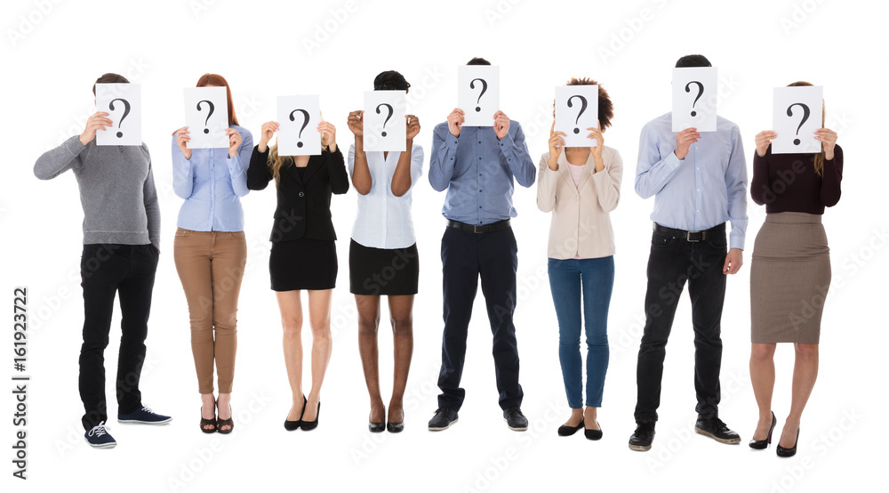 Obraz premium Group Of College Students Hiding Behind Question Mark Sign