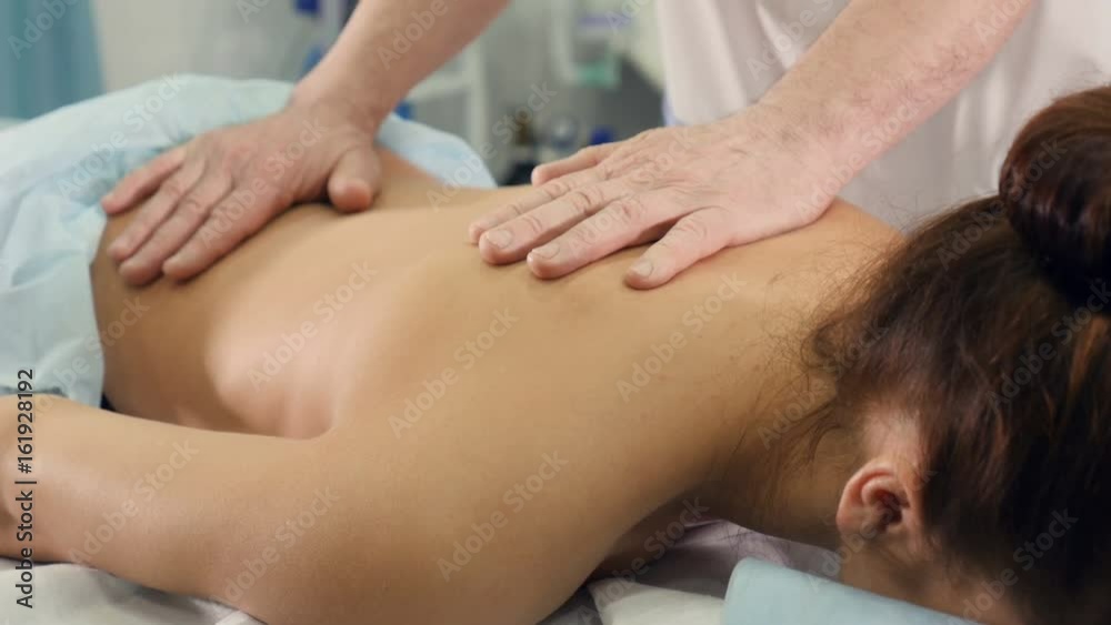 Close up of the massage therapist massaging woman's back Close up of the massage therapist massaging woman's back