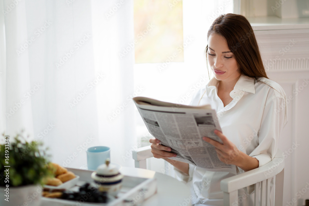 Young beautiful woman reading magazine at table Young beautiful woman reading magazine at table