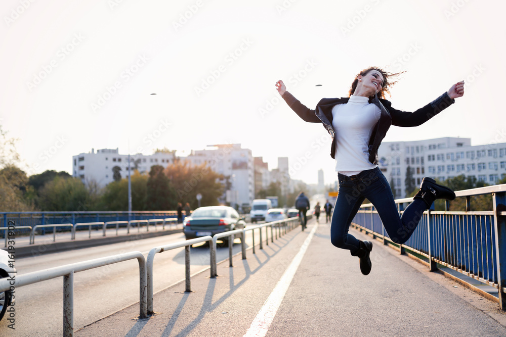 Beautiful happy girl jumping and having fun Beautiful happy girl jumping and having fun