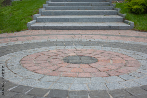 Granite tiles laid out in the form of a circle with an exit through the steps. Another meaning: when you walk around in a circle for a long time, but there is still a way out.
