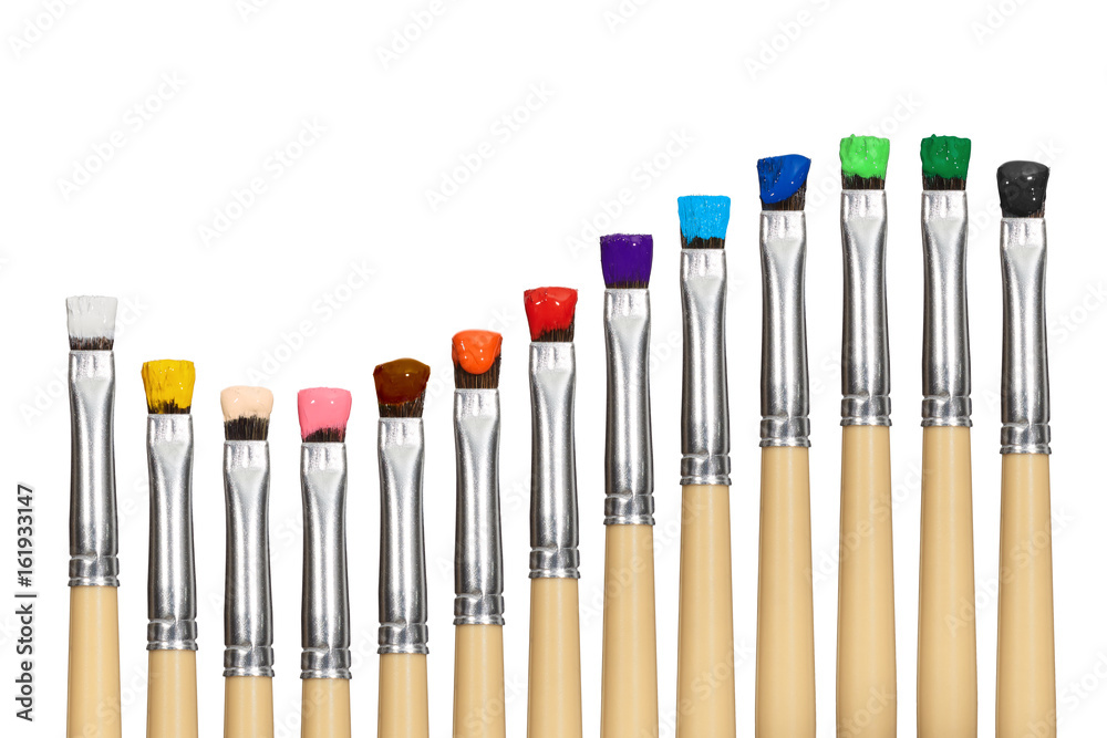 Colored paint brushes row in wave from isolated on white Colored paint brushes row in wave from isolated on white