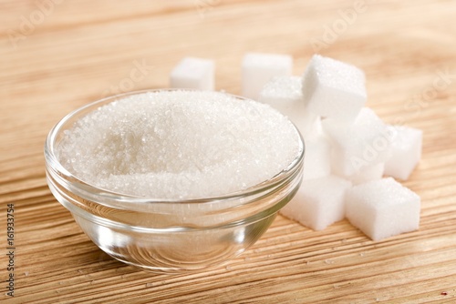 white sugar on wooden background