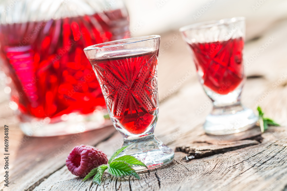 Fresh liqueur with alcohol and raspberries in summer Fresh liqueur with alcohol and raspberries in summer