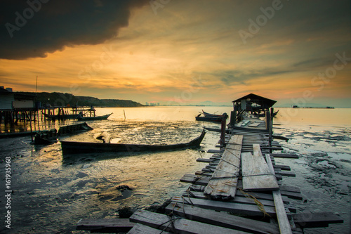 Long Exposure shot of an old jetty during sunrise at Jelutong Jetty, Penang, Malaysia. Soft focus and motion blur due to long exposure shot