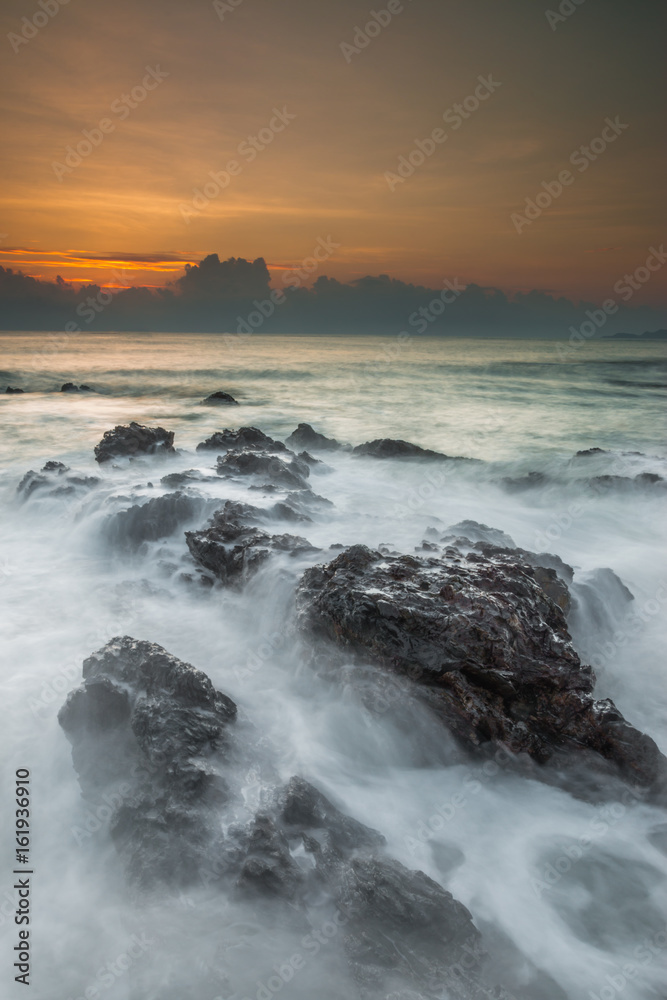 Fototapeta premium Long exposure shot of beautiful sunrise located at Pantai Pandak, Terengganu, Malaysia. Soft focus due to long exposure shot
