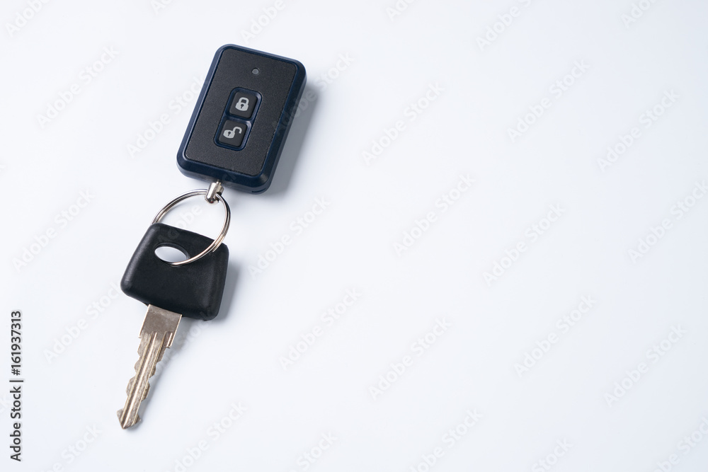 Car key and alarm system charm isolated on a white background with copy spase. car key with remote control Car key and alarm system charm isolated on a white background with copy spase. car key with remote control