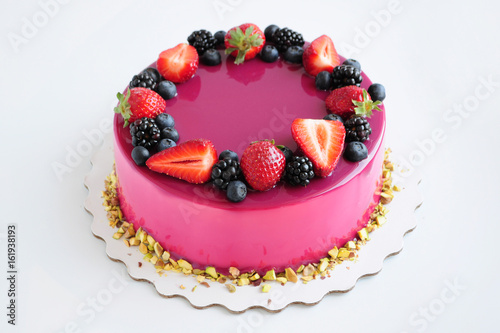 Fotografi Birthday mousse cake with pink mirror glaze and with berries, pistachios