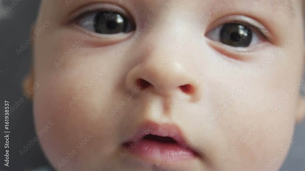infant lies on back with open big eyes infant lies on back with open big eyes