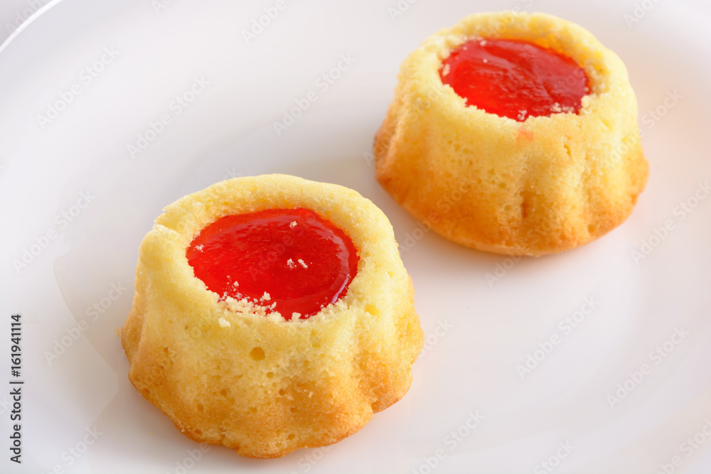 couple of the cookies with strawberry jam on the white plate. Time of tea couple of the cookies with strawberry jam on the white plate. Time of tea