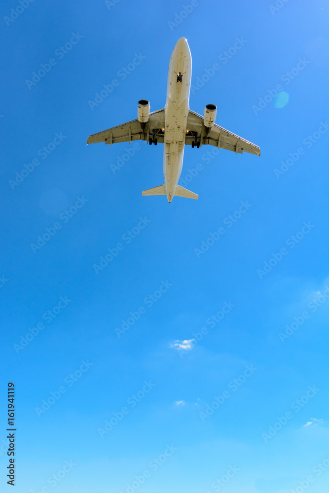 View from below of a flying airliner in landing approach or taking off. View from below of a flying airliner in landing approach or taking off.