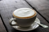 Cup of enery, Cappuccino coffee in white cup on wooden table
