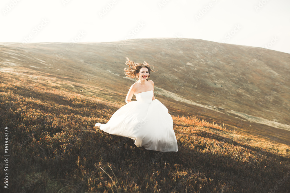 Beauty woman, bride with perfect white dress background mountains