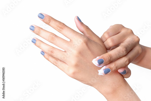 Woman applying hand cream  isolated on a white background