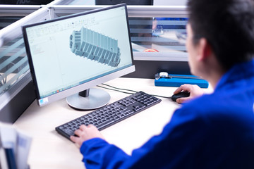 young man makes drawings on computer