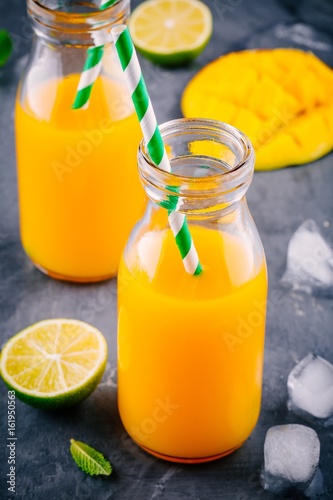 Mango orange juice with ice and lime