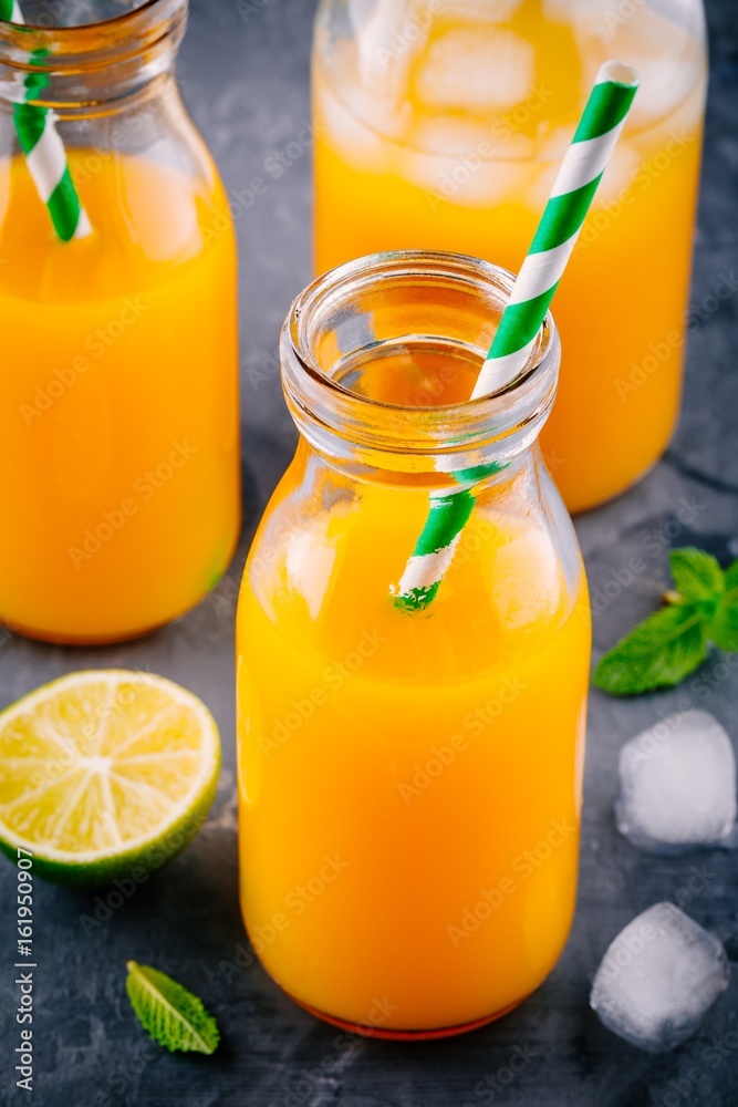 Fototapeta premium Mango orange juice with ice and lime