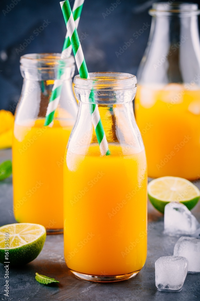 Fototapeta premium Mango orange juice with ice and lime