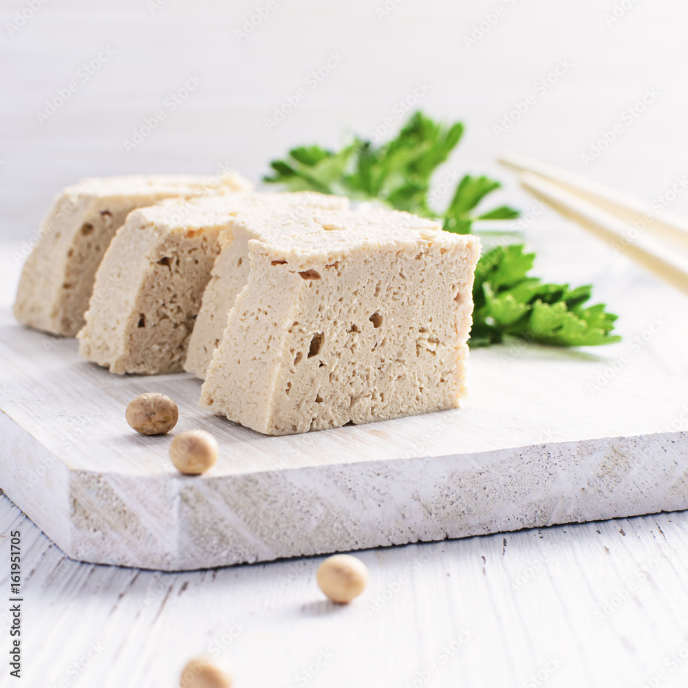 Tofu with fresh coriander on white background.