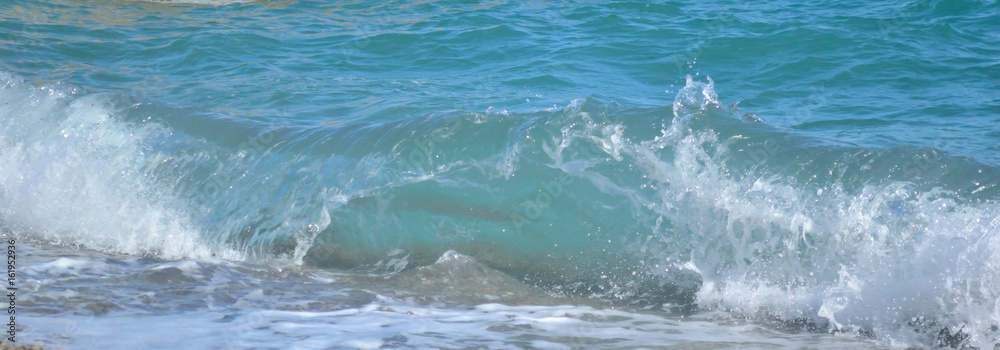 Sea wave rolls to shore