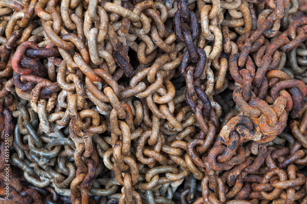 Big rusty chain stacked in a pile at the water shore Big rusty chain stacked in a pile at the water shore