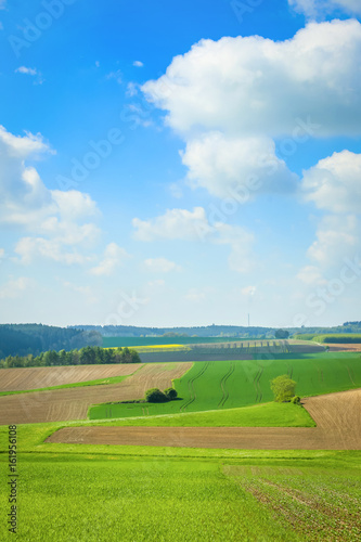 Cultivated fields under the cloudscape in the countryside of Bavaria, Germany.
