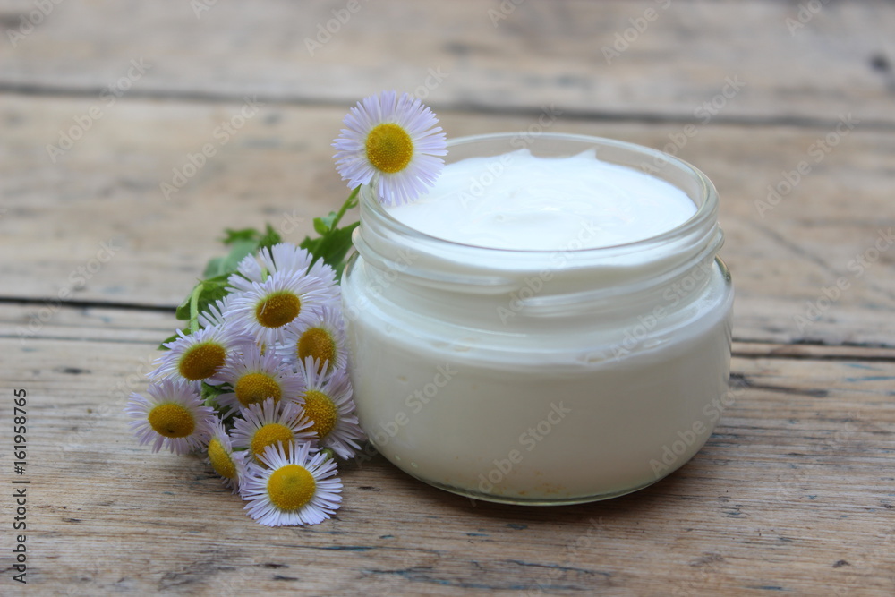 Cosmetic cream with chamomile flowers Cosmetic cream with chamomile flowers